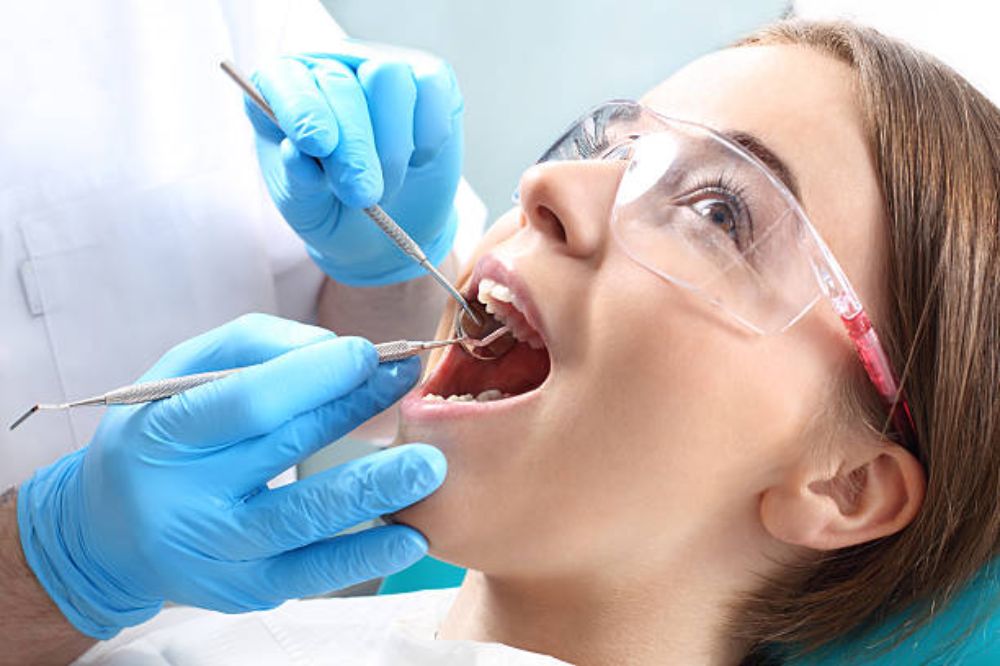 Dental hygienist performing teeth cleaning in Peterborough